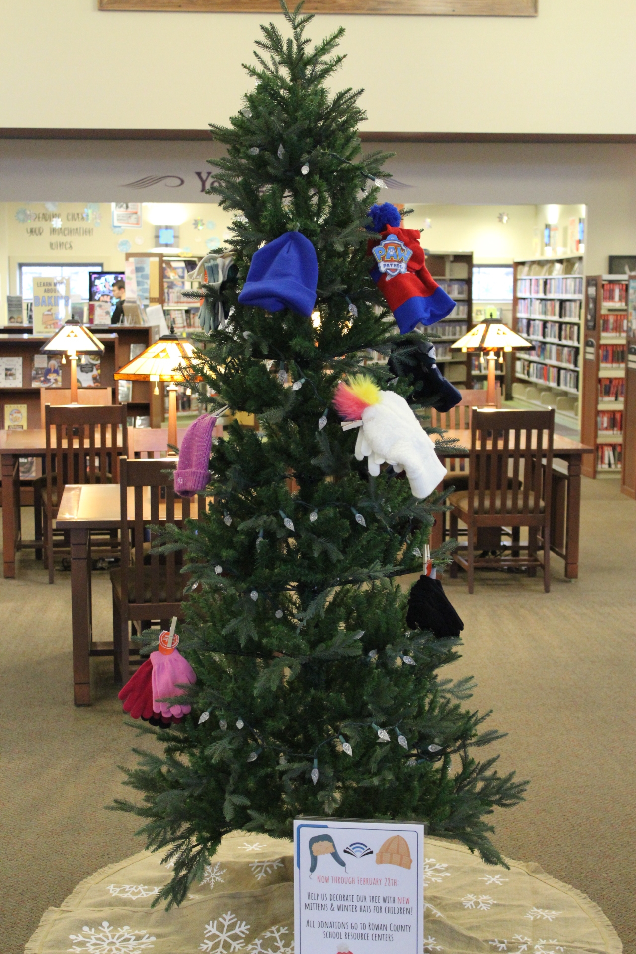 Winter mitten tree with donations on branches