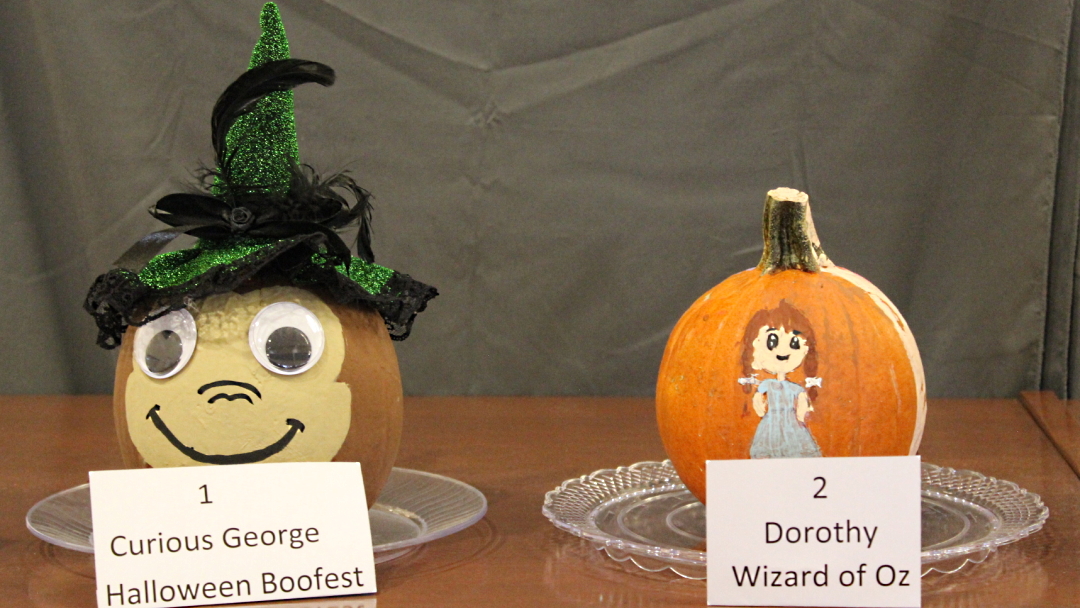 Pumpkins decorated as Curious George and Dorothy from "The Wizard of Oz"