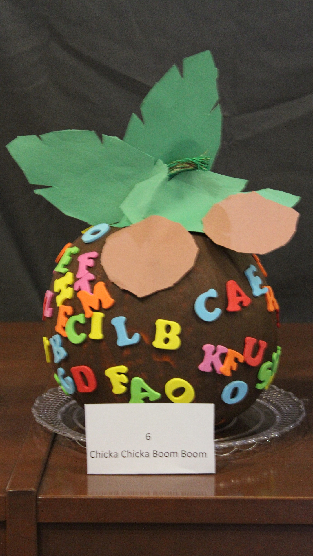 Pumpkin decorated as coconut covered in letters from "Chicka Chicka Boom Boom"