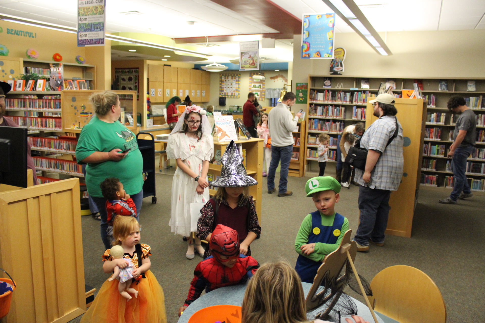 Costumed children playing games in library children's area