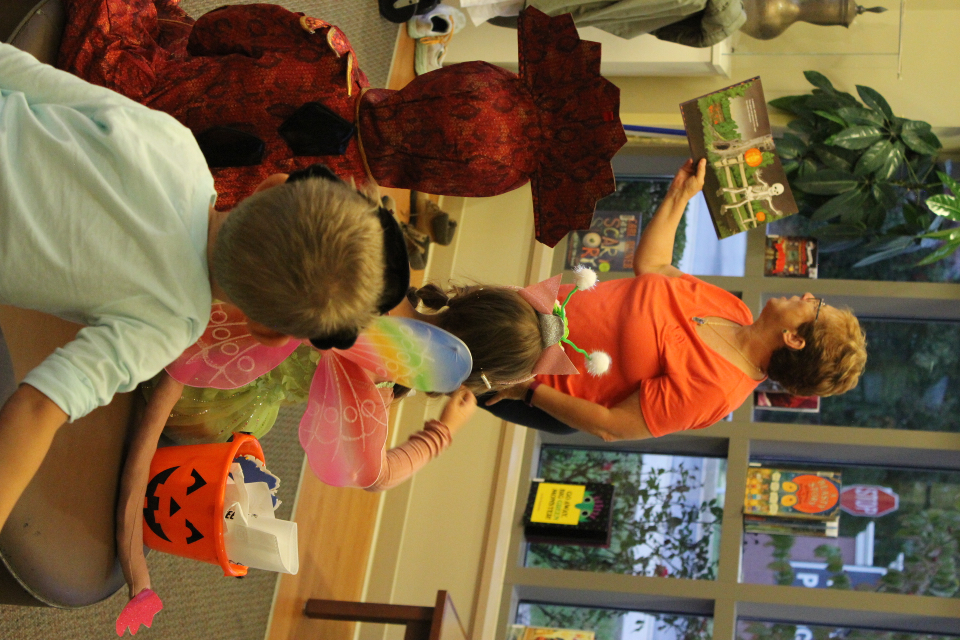 Library Assistant Director Julie reads Halloween stories to costumed children