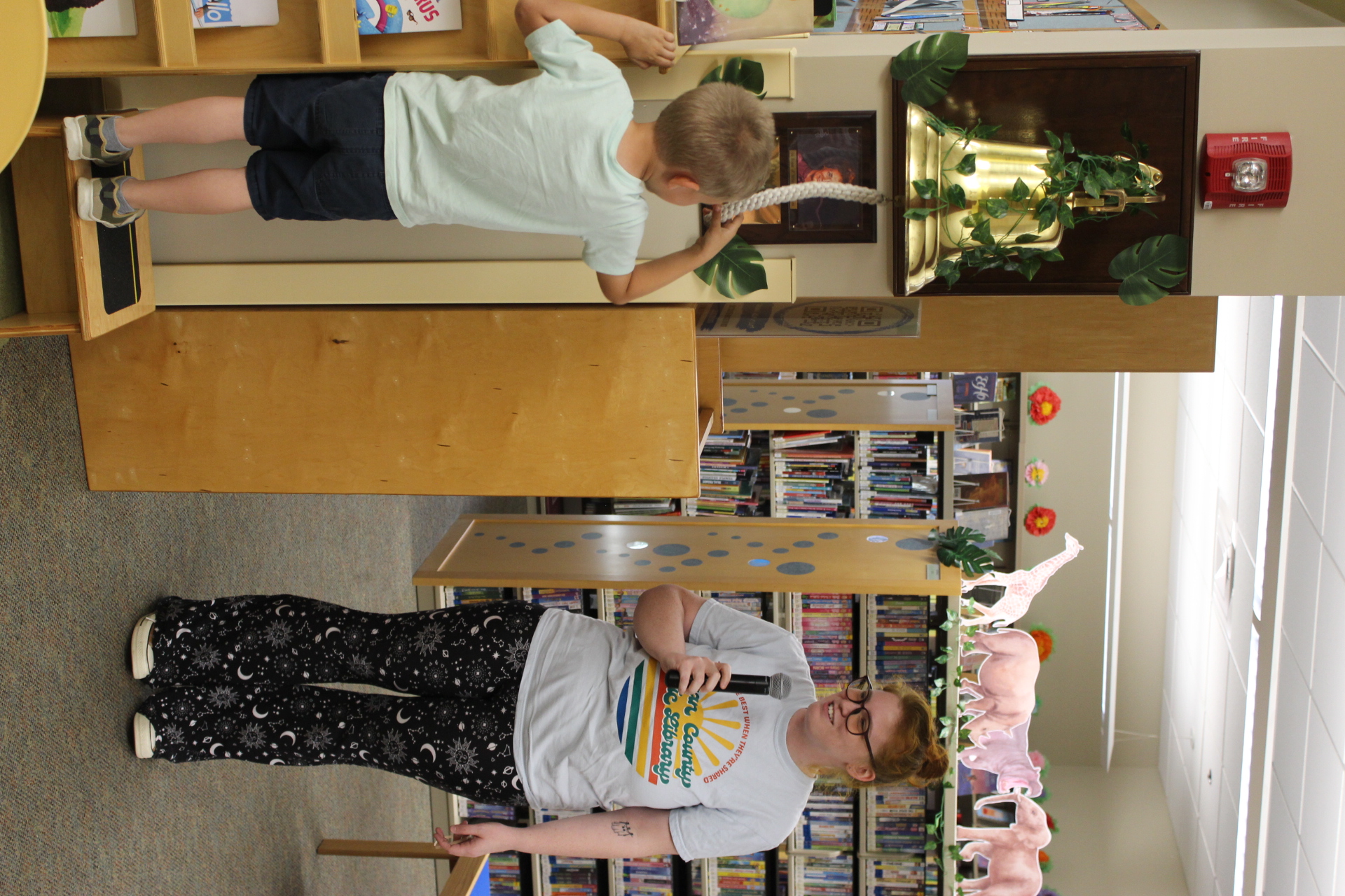 Children's librarian Atlanta watching child ring bell