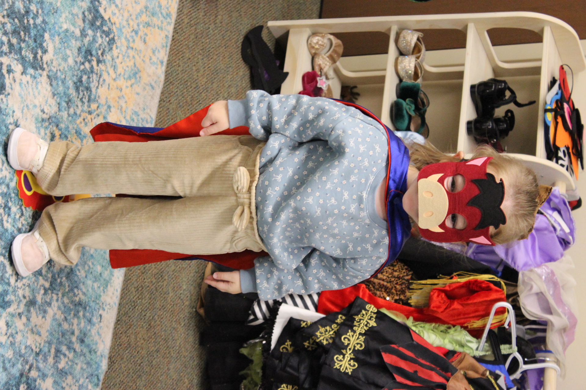 Toddler wearing pieces from several different costumes