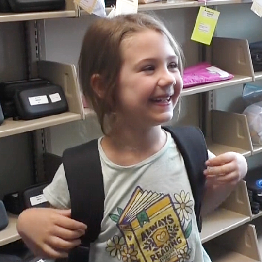Smiling child with backpack